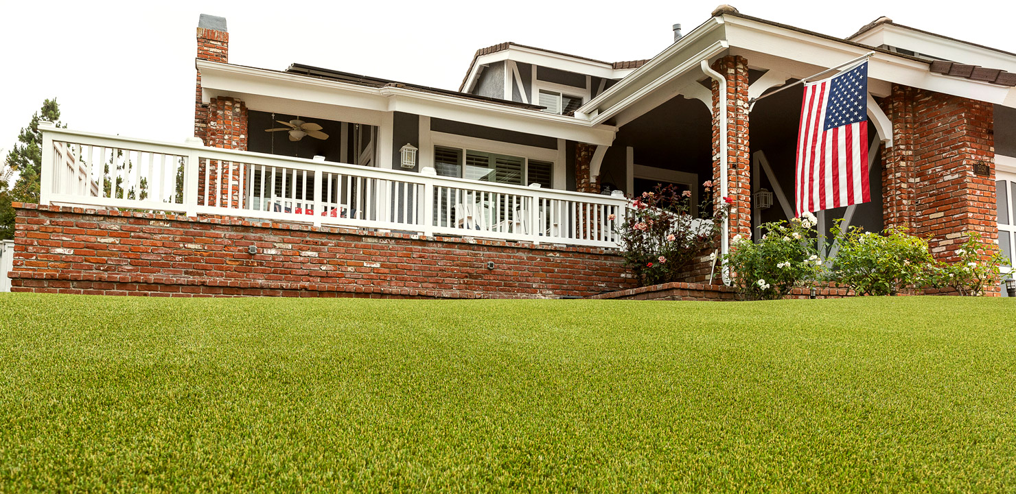 STR_Residential Residential home with an american flag and artificial turf