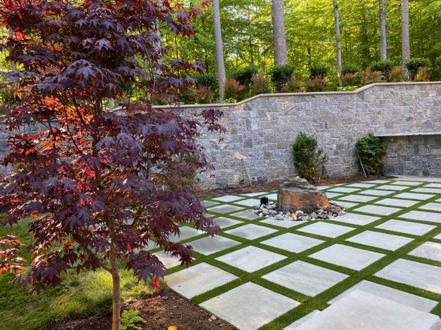 CT75 with pavers Cement pavers and artificial grass in a grid arrangement